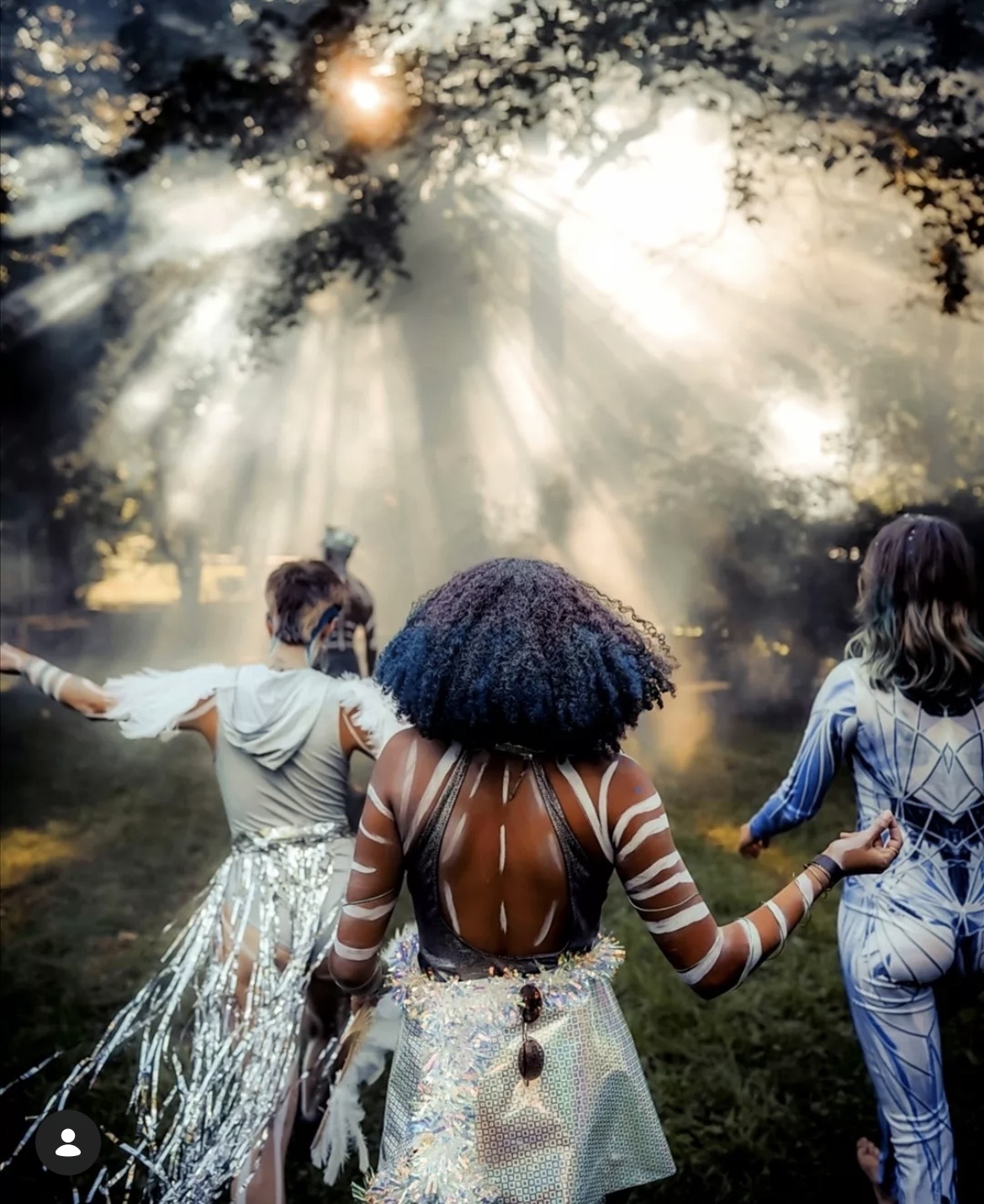 Costumed performers in forest light